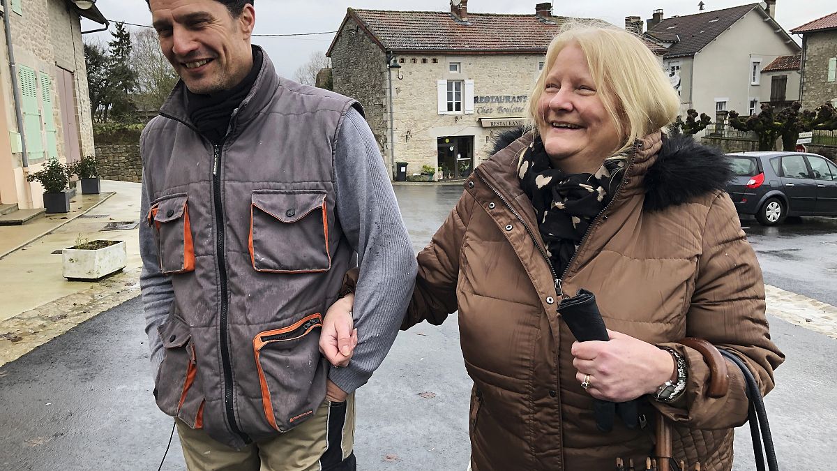 Briton Elaine Bastian walks with her husband, Chris, in the village of Blond, France.