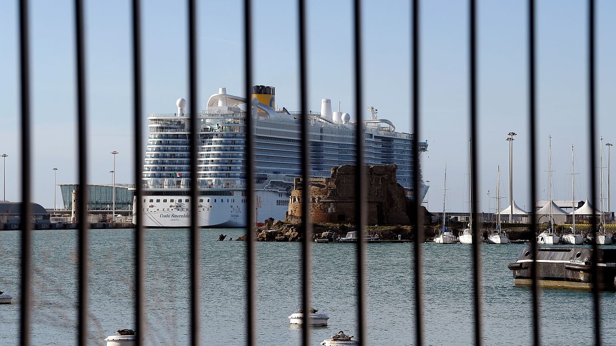The Costa Smeralda cruise ship is seen behind a fence at it is docked in the Civitavecchia port on January 30, 2020