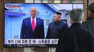 People watch a TV screen showing a file image of North Korean leader Kim Jong Un and U.S. President Donald Trump, during a news program at the Seoul Railway Station
