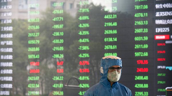Ein Arbeiter mit Maske in der Börse in Shanghai Ein Arbeiter mit Maske in der Börse in Shanghai