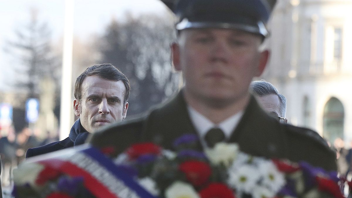 French President Emmanuel Macron takes part in a wreath laying ceremony at the tomb of the Unknown Soldier in Warsaw, Poland, Monday, Feb. 3, 2020.