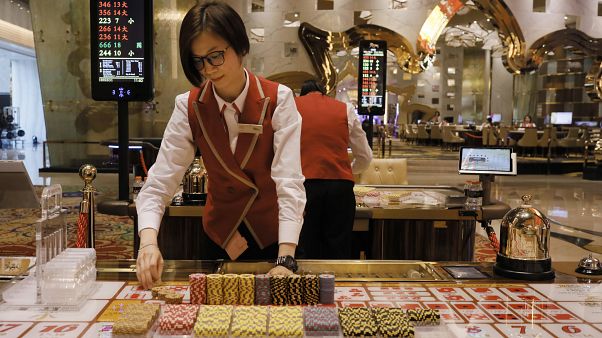 FILE PHOTO : A croupier works at a gaming table at MGM Cotal Rescort in Macau Tuesday, Feb.13, 2018. FILE PHOTO : A croupier works at a gaming table at MGM Cotal Rescort in Macau Tuesday, Feb.13, 2018.