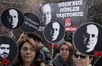 Turkish women hold posters of Ugur Mumcu, Turkey's best-known investigative journalist, who was killed in 1993, and one of Ali Ismail Korkmaz