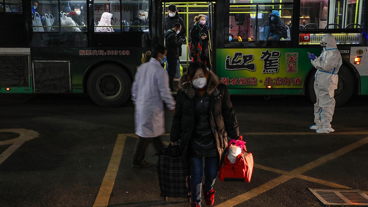 This photo taken on February 5, 2020 shows patients displaying mild symptoms of the novel coronavirus as they arrive at an exhibition centre converted into a hospital in Wuhan