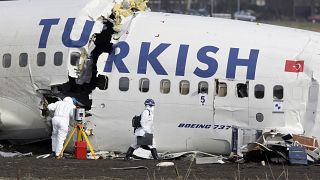 Crash investigators examine the wreckage of the Turkish airlines plane at Amsterdam's Schiphol Airport, Thursday, Feb. 26, 2009.