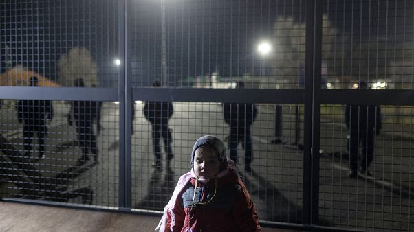 A child stands at the border line between Serbia and Hungary in Kelebija, Serbia, A child stands at the border line between Serbia and Hungary in Kelebija, Serbia,