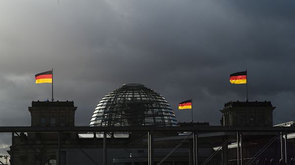 German national flags catch the sun on top of the German parliament building, the Reichstag building in Berlin, Germany, Friday, Nov. 29, 2019. German national flags catch the sun on top of the German parliament building, the Reichstag building in Berlin, Germany, Friday, Nov. 29, 2019.