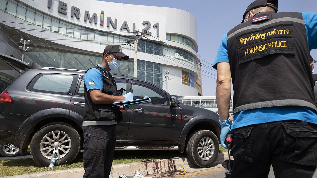 Forensic officers inspect a shooting scene outside the Terminal 21 Korat mall in Nakhon Ratchasima, Thailand, Sunday, Feb. 9, 2020.