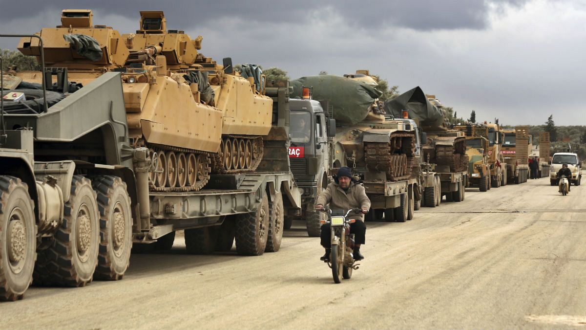 Turkish military convoy drives through the village of Binnish, in Idlib province, Syria, Saturday, Feb. 8, 2020.