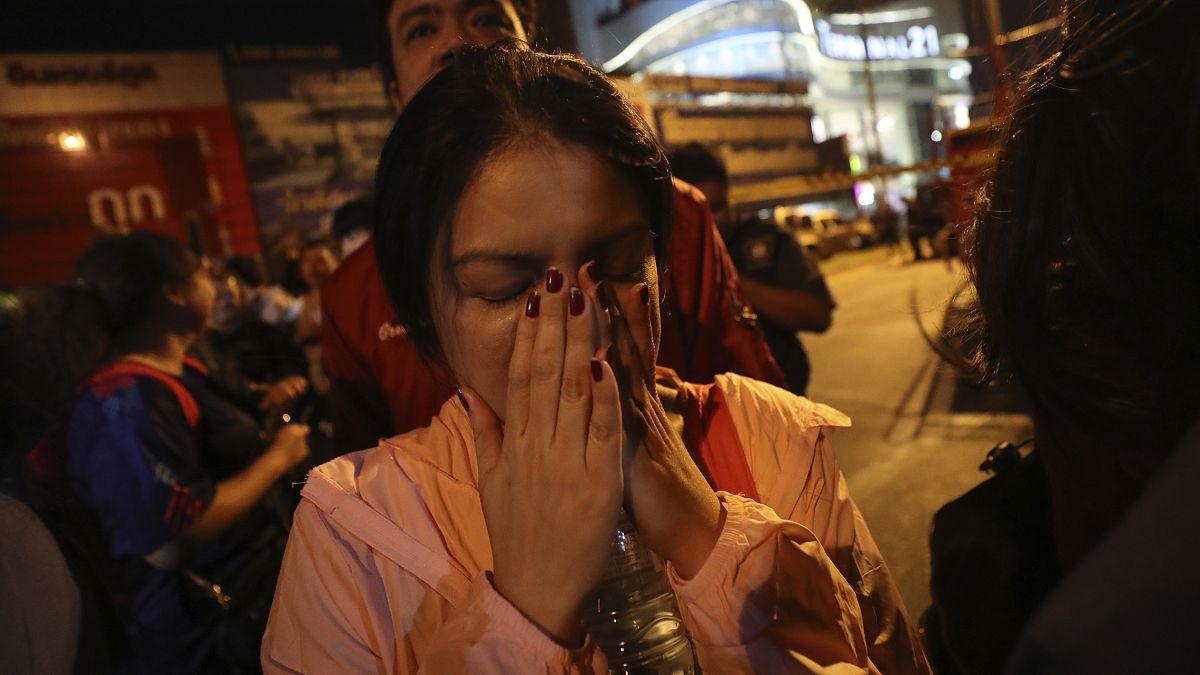 A woman who was able to get out of Terminal 21 Korat mall gestures with her hands on her face in Nakhon Ratchasima, Thailand on Sunday, Feb. 9, 2020