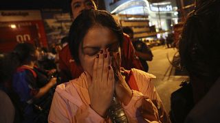 A woman who was able to get out of Terminal 21 Korat mall gestures with her hands on her face in Nakhon Ratchasima, Thailand on Sunday, Feb. 9, 2020