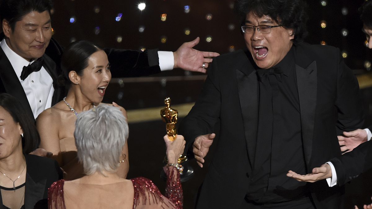 Bong Joon Ho, right, reacts as he is presented with the award for best picture for "Parasite" from presenter Jane Fonda at the Oscars on Sunday, Feb. 9, 2020.
