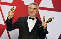 Alfonso Cuaron posa con los premios al mejor director para "Roma", mejor película en lengua"Roma", y mejor fotografía para "Roma" en febrero de 2019