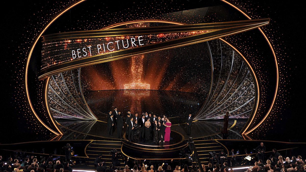 The cast and crew of "Parasite" accept the award for best picture at the Oscars 