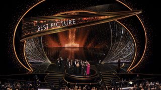 The cast and crew of "Parasite" accept the award for best picture at the Oscars