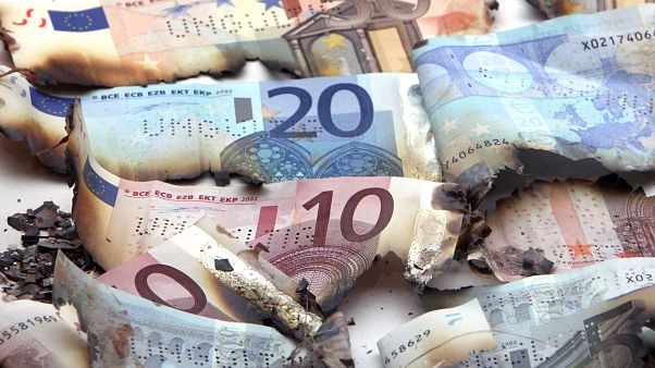 Burnt Euro notes are displayed in the money museum of German Bundesbank in Frankfurt, Germany, Wednesday, Sept.14, 2011.(AP Photo/Michael Probst) Burnt Euro notes are displayed in the money museum of German Bundesbank in Frankfurt, Germany, Wednesday, Sept.14, 2011.(AP Photo/Michael Probst)