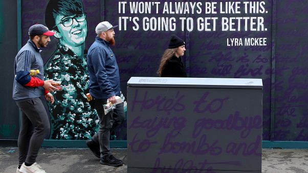 FILE PHOTO: Residents walk past a newly painted mural featuring murdered journalist Lyra McKee in central Belfast on May 7, 2019. FILE PHOTO: Residents walk past a newly painted mural featuring murdered journalist Lyra McKee in central Belfast on May 7, 2019.