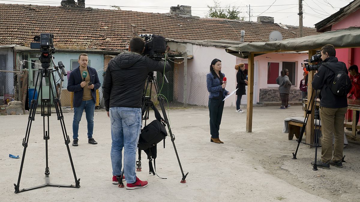 FILE PHOTO: Television reporters stand outside the house of Severin Krassimirov, suspect in the killing of journalist Viktoria Marinova 