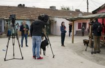 FILE PHOTO: Television reporters stand outside the house of Severin Krassimirov, suspect in the killing of journalist Viktoria Marinova