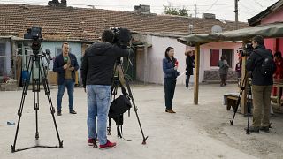 FILE PHOTO: Television reporters stand outside the house of Severin Krassimirov, suspect in the killing of journalist Viktoria Marinova 