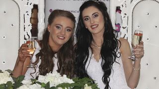 Robyn Peoples, left, and Sharni Edwards pose together after becoming the first same sex couple to marry in Northern Ireland, in Carrickfergus, Tuesday Feb. 11, 2020