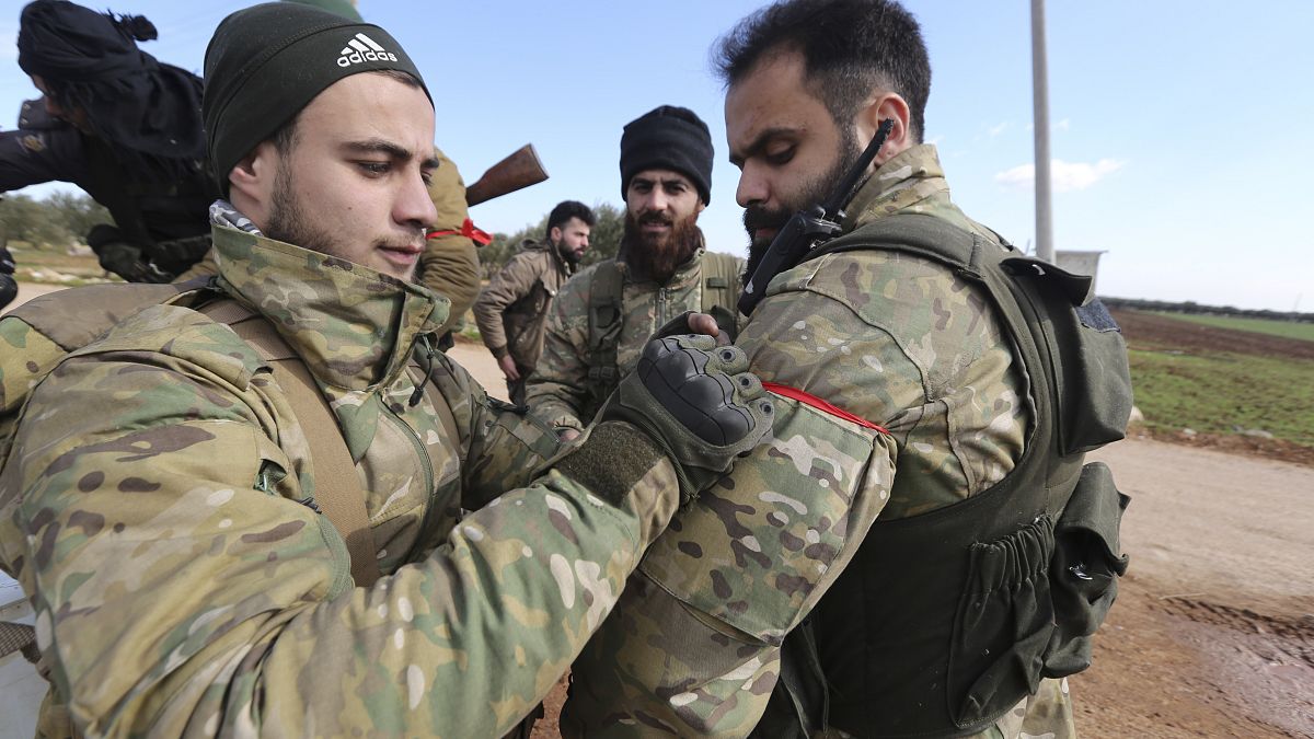Turkish backed fighter prepare to go to the frontline in the Syrian province of Idlib, Monday, Feb. 10, 2020. 