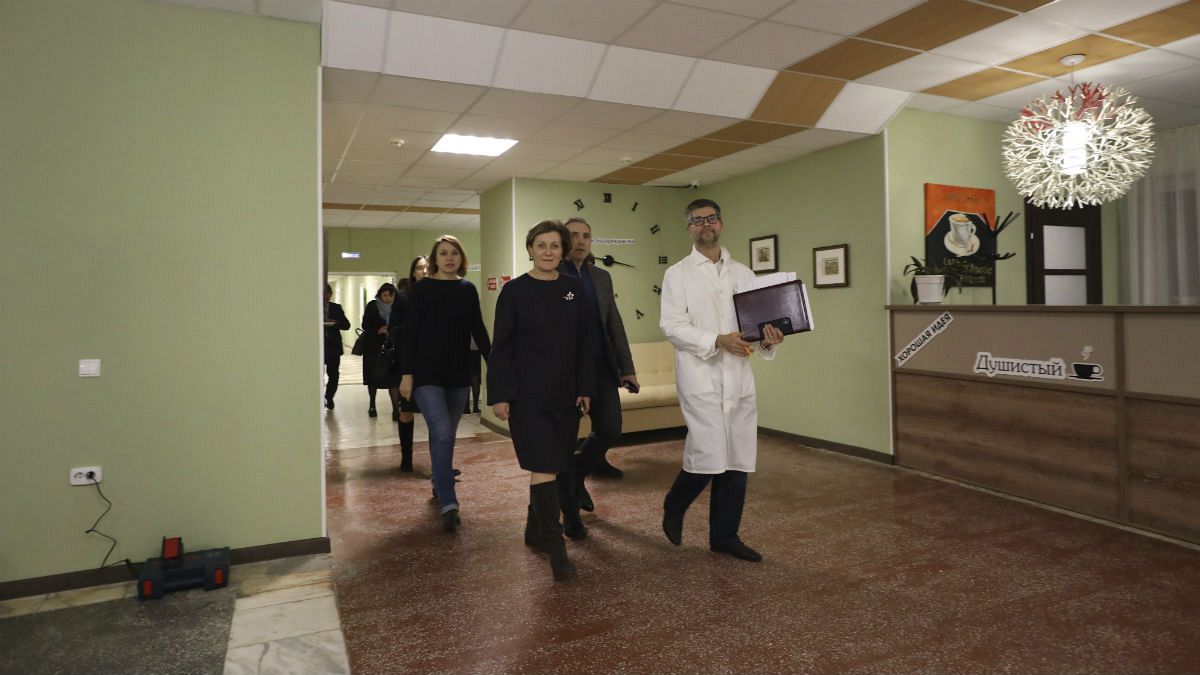 A group of local officials walk inside the sanatorium in Bogandinsky in the Tyumen region, about 2150 kilometers (1344 miles) east of Moscow, western Siberia, Russia, Tuesday,