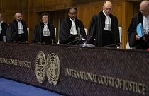 Presiding judge Abdulqawi Ahmed Yusuf, center, and other judges take their seats at the International Court in The Hague, Netherlands, Thursday, Jan. 23, 2020