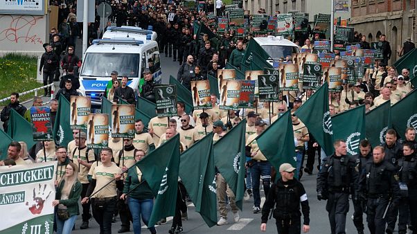 Protestors march with flags during a demonstration of the far-right party 'The third way' in Plauen, Germany, Wednesday, May 1, 2019 Protestors march with flags during a demonstration of the far-right party 'The third way' in Plauen, Germany, Wednesday, May 1, 2019
