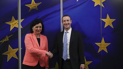 European Commissioner for Values and Transparency Vera Jourova with Facebook CEO Mark Zuckerberg in Brussels, Feb. 17, 2020. (AP Photo/Francisco Seco)