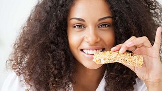 Girl eating a cereal bar