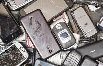 In this photo taken on July 13, 2018, old mobile phones fill a bin at the Out Of Use company warehouse in Beringen, Belgium