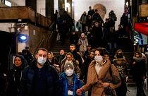 A family wearing a face mask walk in Biblioteka Imeni Lenina metro station in Moscow on February 7, 2020.
