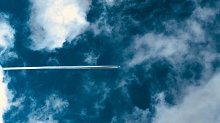 These cloud trails are created by ice crystals that form around carbon particles emitted by the engines. 