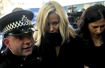 Love Island TV presenter Caroline Flack, centre, escorted by police, as she arrives at Highbury Magistrates' Court in London, Monday, Dec. 23, 2019.