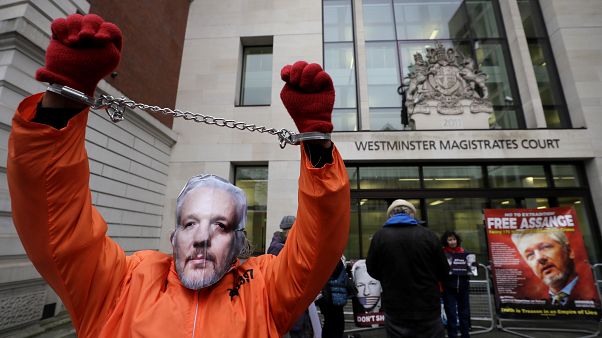 FILE PHOTO: A demonstrator supporting Julian Assange wears a mask and chains outside Westminster Magistrates Court in London, Thursday, Jan. 23, 2020. FILE PHOTO: A demonstrator supporting Julian Assange wears a mask and chains outside Westminster Magistrates Court in London, Thursday, Jan. 23, 2020.