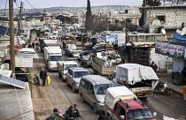 Civilians flee from Idlib toward the north to find safety inside Syria near the border with Turkey, Saturday, Feb. 15, 2020.