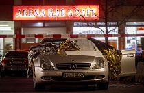 A car with dead bodies stands in front of a bar in Hanua, Germany Thursday, Feb. 20,