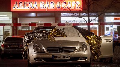 A car with dead bodies stands in front of a bar in Hanua, Germany Thursday, Feb. 20, 