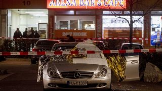 A car in front of one the two bars attacked in Hanau, Germany Thursday, Feb. 20, 2020. (AP Photo/Michael Probst)