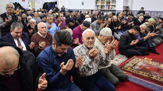 Muslim believers pray in a mosque for the victims of the shooting in Hanau, Germany, Friday, Feb. 21, 2020.