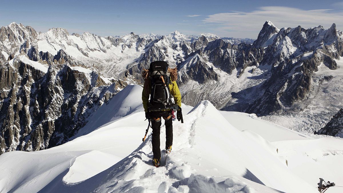 an alpinist heads down a ridge on the Aiguille du Midi towards the Vallee Blanche on the Mont Blanc massif, in the Alps, France on Oct. 12, 2011.
