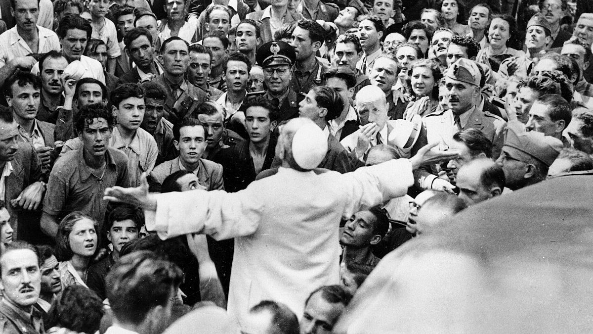 In this Oct. 15, 1943 file photo, men, women and soldiers gather around Pope Pius XII in Rome, Italy 