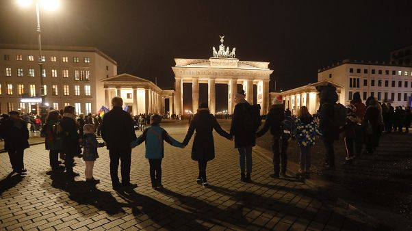 People stand for a human chain during a vigil for victims of last night's shooting in Hanau People stand for a human chain during a vigil for victims of last night's shooting in Hanau