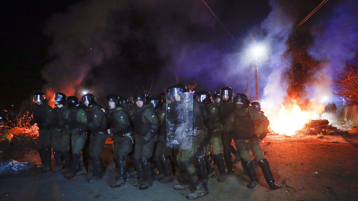 La policía antidisturbios ucraniana se prepara para hacer retroceder a los manifestantes en las afueras de Novi Sarzhany, Ucrania