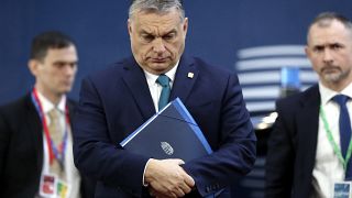 Hungarian Prime Minister Viktor Orban, center, arrives for an EU summit at the European Council building in Brussels, Friday, Feb. 21, 2020.