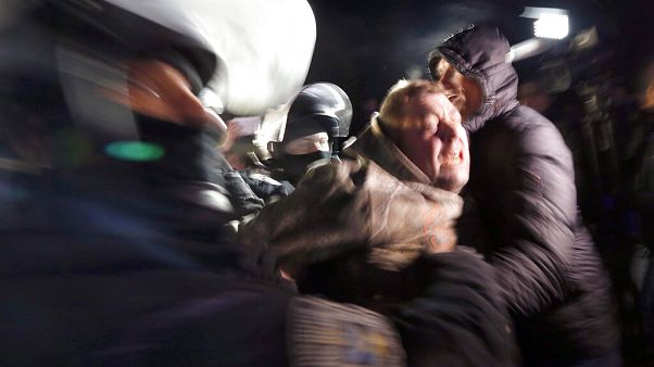 Ukrainian riot police detain a protester, who planned to stop buses carrying passengers evacuated from the Chinese city of Wuhan, outside Novi Sarzhany, Ukraine. Ukrainian riot police detain a protester, who planned to stop buses carrying passengers evacuated from the Chinese city of Wuhan, outside Novi Sarzhany, Ukraine.