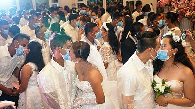 أزواج فلبينيون يتبادلون القبل وهم يرتدون الأقنعة خشية انتشار فيروس كوفيد-19. 2020/02/21