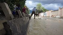 Bolivians clean up after river flood forces evacuation