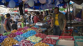 Palestinians buy sweets for upcoming Eid al-Adha holiday at the central Gaza main market in Gaza City, in the northern Gaza Strip